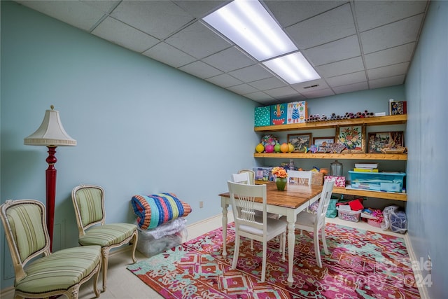 playroom with a paneled ceiling