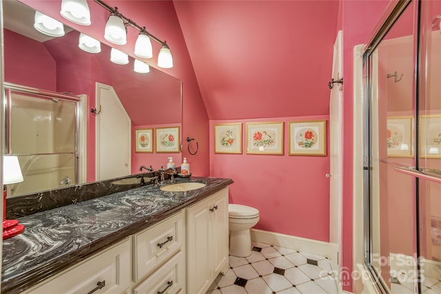 bathroom with lofted ceiling, toilet, a shower stall, and vanity