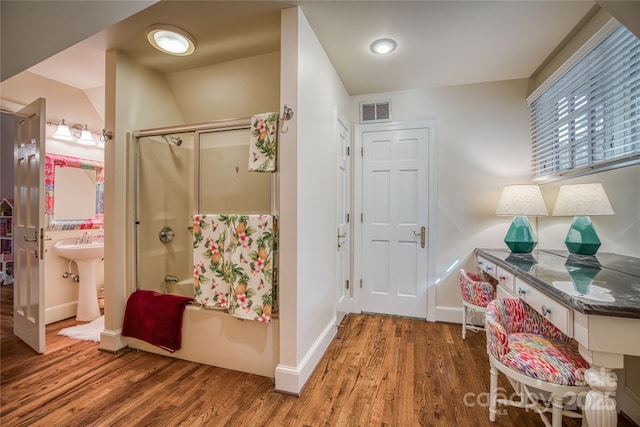 interior space featuring wood finished floors, visible vents, and baseboards