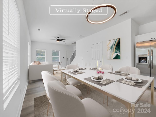 dining area with ceiling fan and light hardwood / wood-style floors