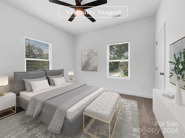 bedroom featuring ceiling fan and dark colored carpet