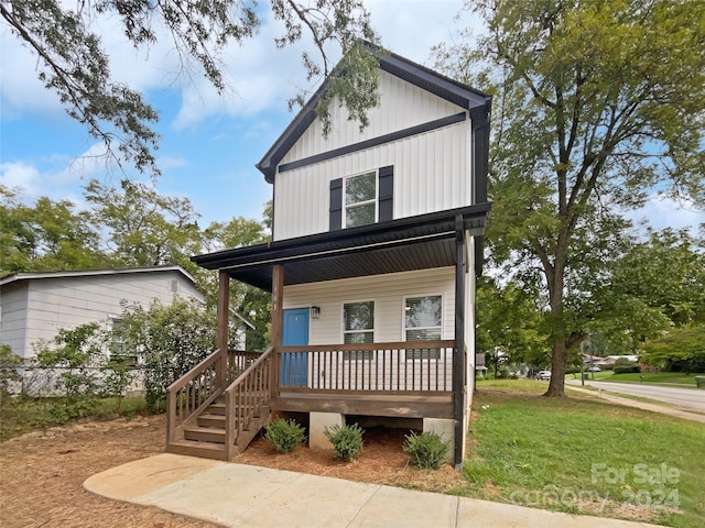 view of front of property with a porch and a front lawn