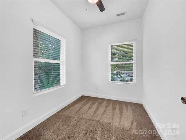 carpeted empty room featuring ceiling fan