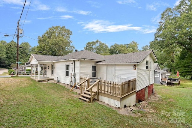 back of house featuring a yard and a deck