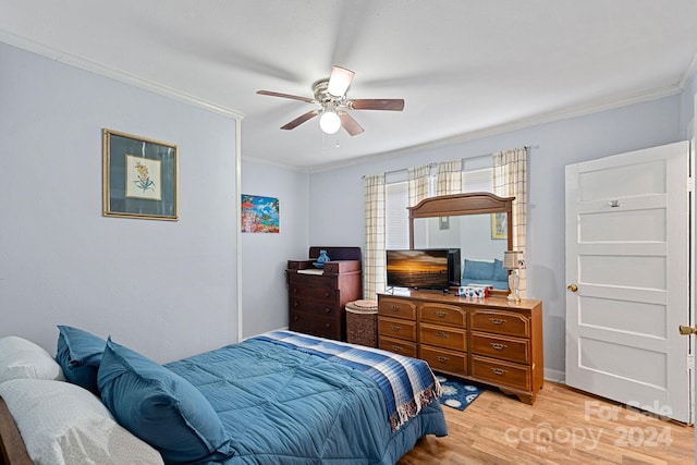 bedroom featuring ceiling fan, light hardwood / wood-style floors, and ornamental molding