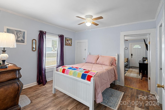 bedroom with dark wood-type flooring, ceiling fan, and ornamental molding