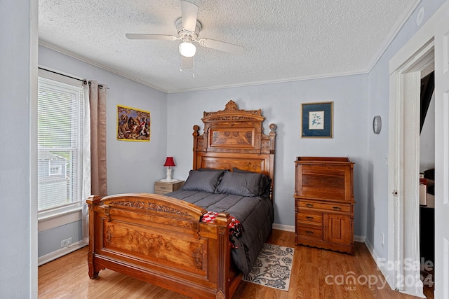 900 Alma Ave, Kannapolis, NC 28081 - bedroom featuring a ceiling fan, wood finished floors, a textured ceiling, baseboards, and ornamental molding