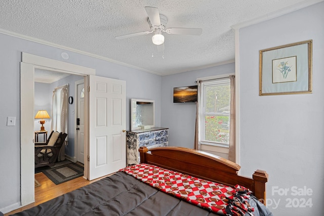 900 Alma Ave, Kannapolis, NC 28081 - bedroom featuring a textured ceiling, ornamental molding, wood finished floors, and a ceiling fan