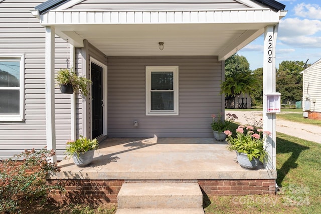 view of exterior entry with covered porch