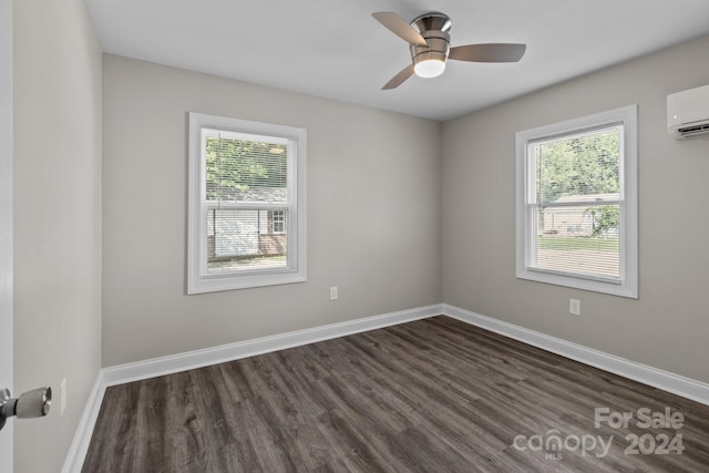 spare room with ceiling fan, dark wood-type flooring, and a wall mounted AC