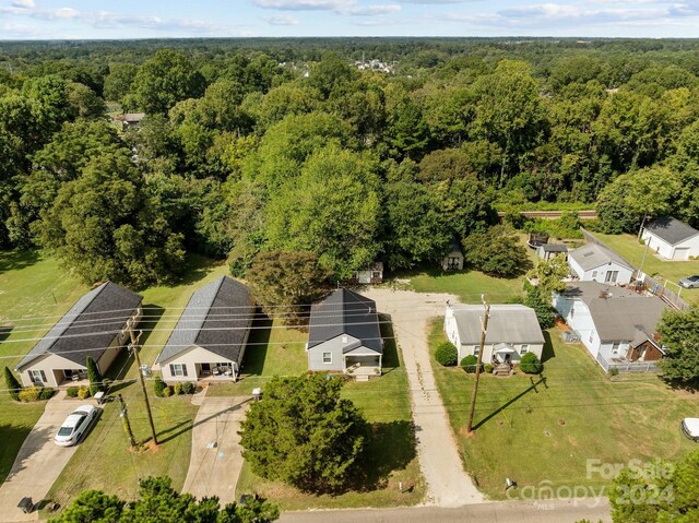 birds eye view of property with a wooded view