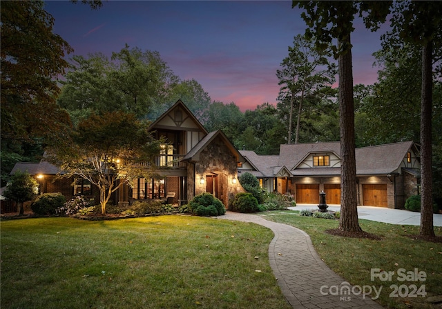 view of front of property featuring a lawn and a garage