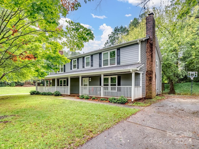 view of front of property with a porch and a front lawn