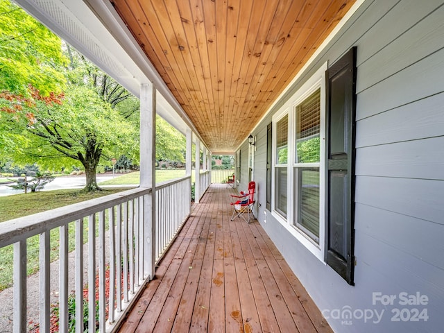 wooden terrace featuring covered porch