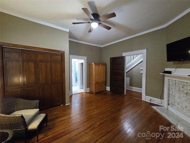 bedroom with ornamental molding, ceiling fan, dark wood-type flooring, and a closet