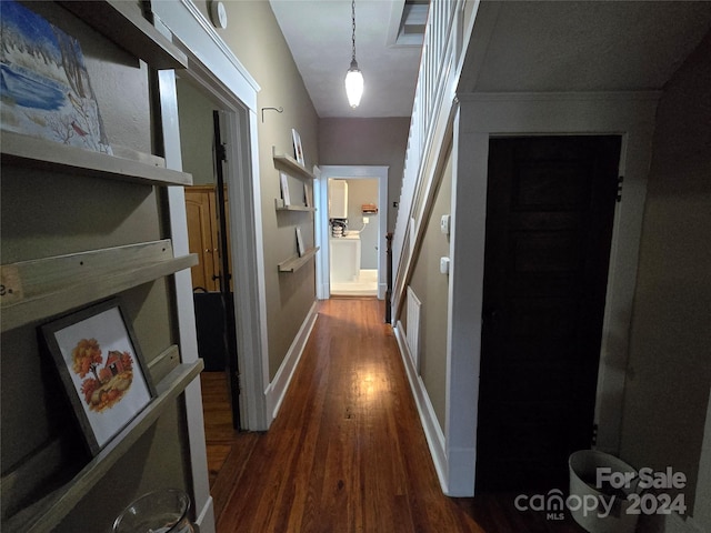 hall with dark wood-type flooring