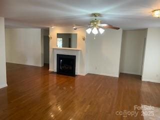 unfurnished living room featuring dark wood-type flooring