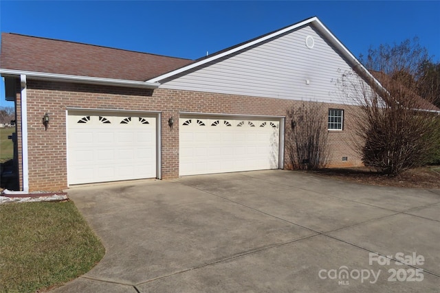 view of side of home featuring a garage