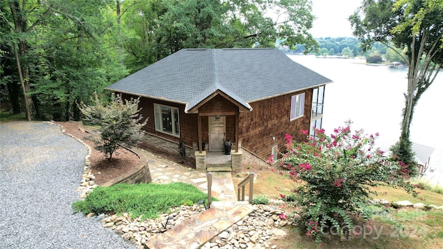 view of front of property with a porch and a water view