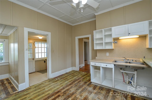 kitchen featuring wood-type flooring, crown molding, white cabinetry, and ceiling fan