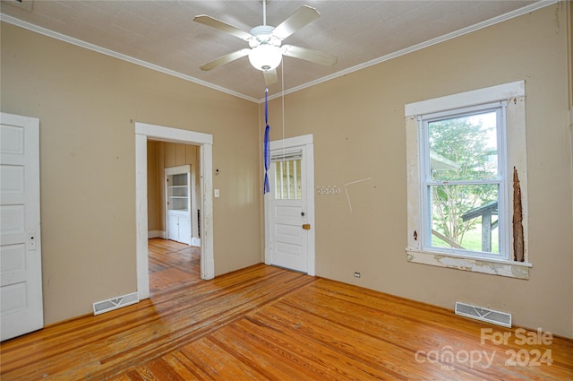 spare room with crown molding, ceiling fan, and light hardwood / wood-style flooring