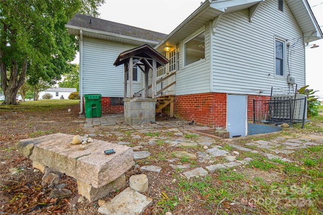 view of property exterior featuring cooling unit and a patio