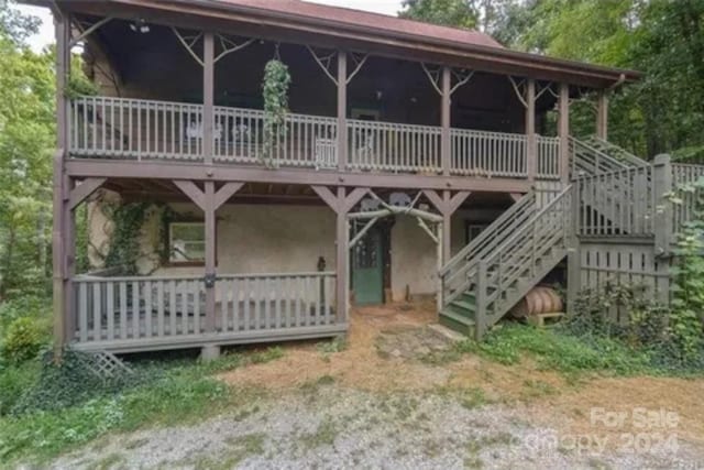 rear view of house featuring a deck