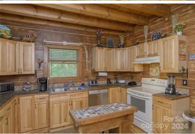 kitchen featuring light brown cabinetry, appliances with stainless steel finishes, and sink