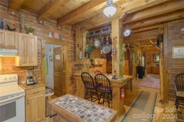 kitchen with range hood, wood walls, light brown cabinetry, and white electric stove