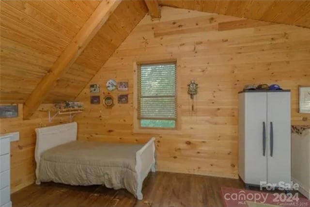 bedroom featuring vaulted ceiling with beams, hardwood / wood-style flooring, and wooden walls