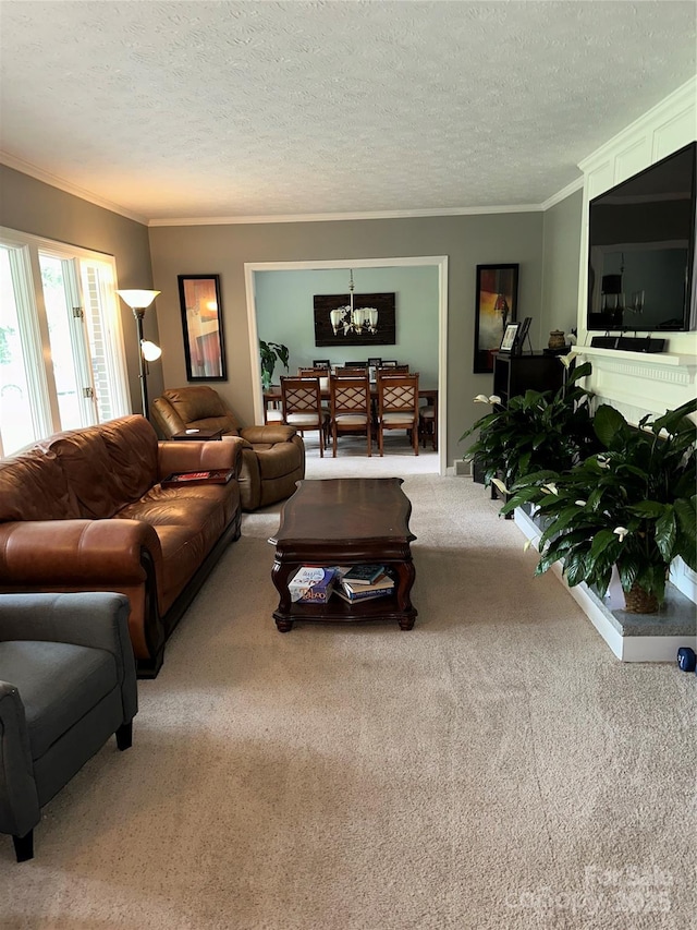 carpeted living area with a textured ceiling, ornamental molding, and a notable chandelier