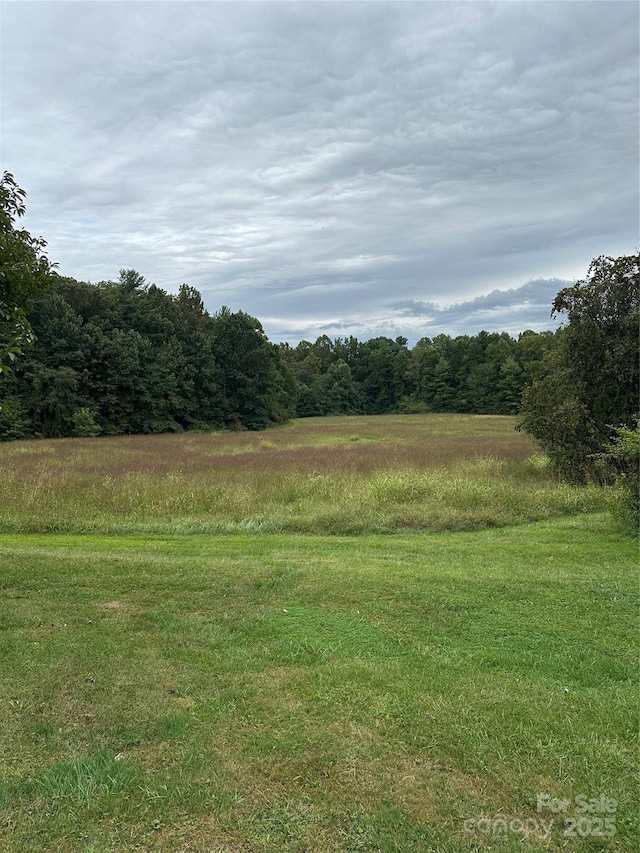 view of landscape featuring a forest view