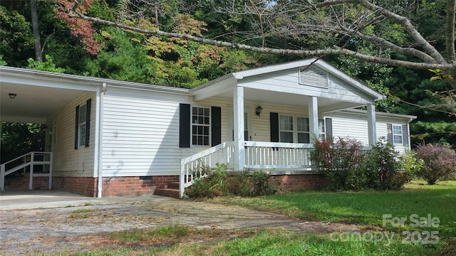 view of front of home featuring crawl space, a porch, and a carport