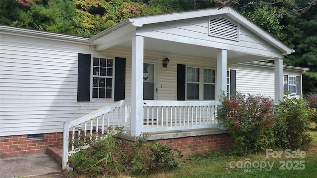 entrance to property featuring crawl space and a porch