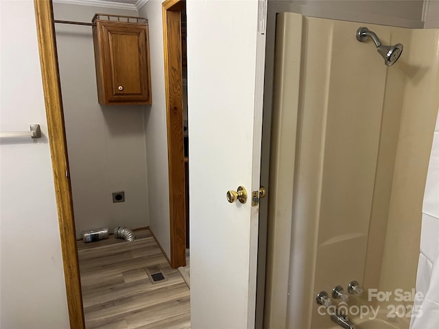 full bathroom with shower / bathing tub combination, wood finished floors, and visible vents