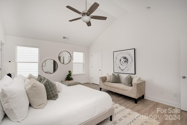 bedroom featuring light hardwood / wood-style floors, ceiling fan, and high vaulted ceiling