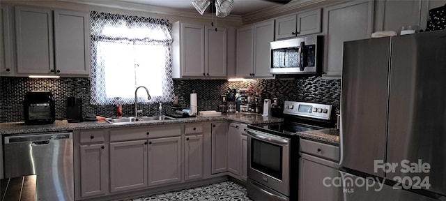 kitchen with ceiling fan, stone counters, sink, backsplash, and appliances with stainless steel finishes