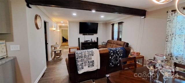 living room featuring crown molding, beamed ceiling, and hardwood / wood-style floors