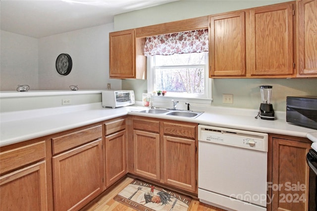 kitchen with white dishwasher, black electric range oven, light wood-type flooring, and sink