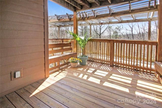 snow covered deck featuring a pergola