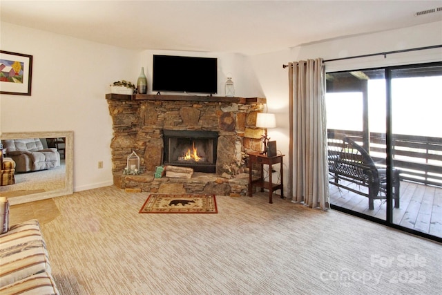 living room with a stone fireplace