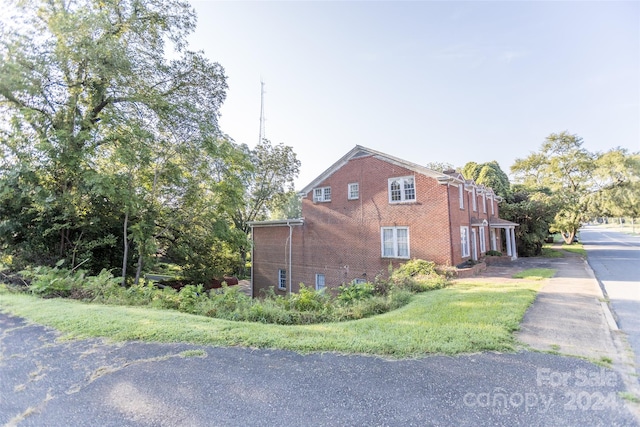 view of property exterior featuring a lawn