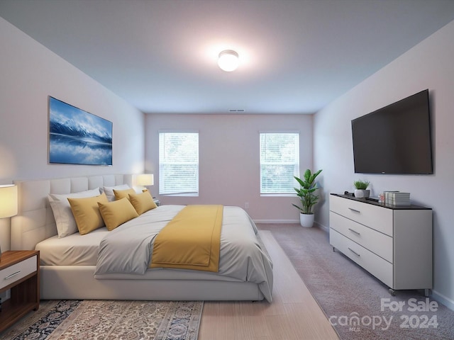 bedroom featuring light colored carpet