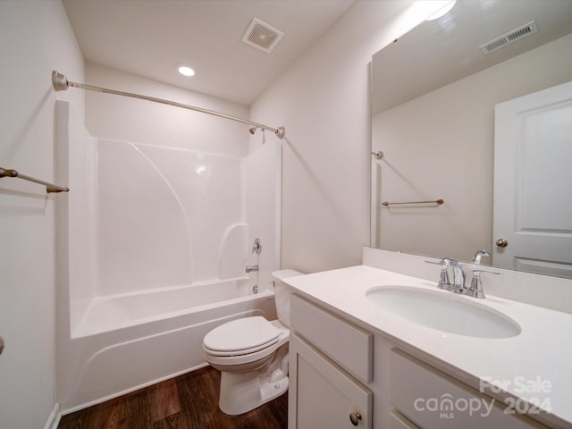 full bathroom with toilet, vanity, hardwood / wood-style flooring, and shower / washtub combination