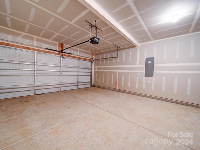 garage with electric panel and a garage door opener