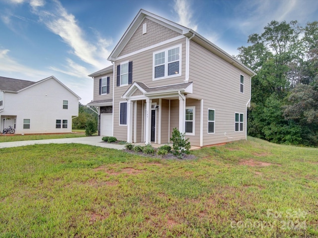 view of front of home with a garage and a front lawn