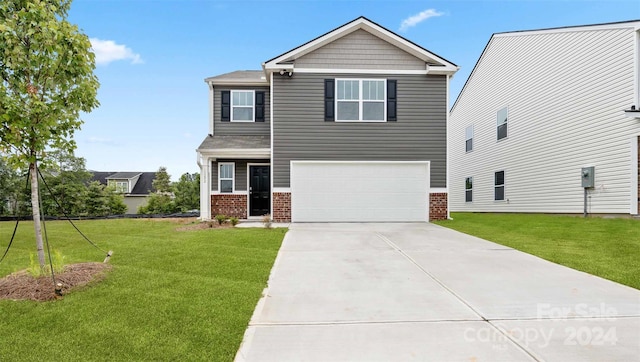 view of front of house with a garage and a front lawn