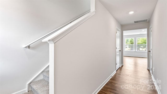 hallway with dark hardwood / wood-style flooring