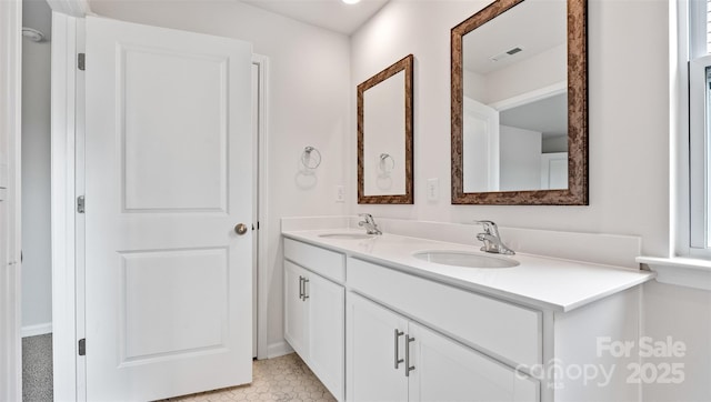 bathroom featuring double vanity, a sink, and visible vents