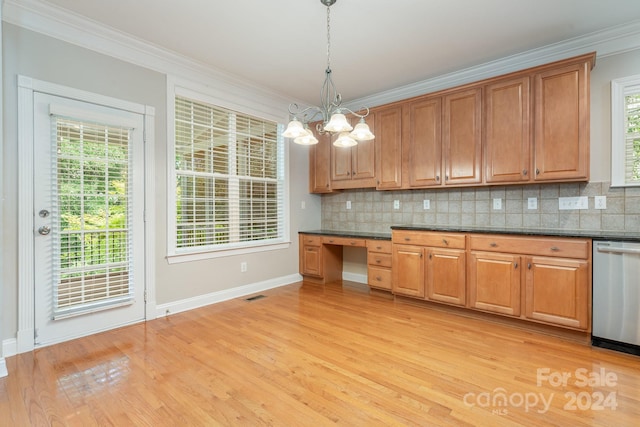 kitchen with hanging light fixtures, stainless steel dishwasher, and plenty of natural light